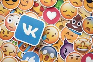 KYIV, UKRAINE - APRIL 20, 2024 VK logo and large set of stickers with Emoji yellow faces. Emoji is a pictogram or smiley embedded in text and used in electronic messages photo
