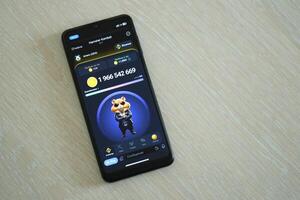 KYIV, UKRAINE - APRIL 20, 2024 Hamster Kombat telegram bot on smartphone screen. Hamster Kombat is a viral Telegram crypto game for earn HMSTR tokens by managing virtual crypto exchange photo