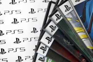 KYIV, UKRAINE - JUNE 26, 2024 Stack of games for Sony Playstation 5 and 4 console. Many disc boxes of popular games photo
