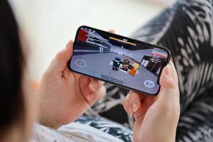 Roblox mobile iOS game on iPhone 15 smartphone screen in female hands during mobile gameplay photo