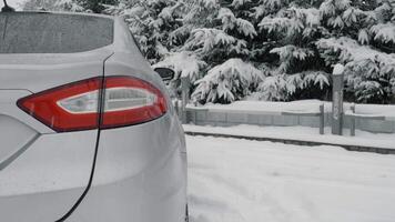 Car and heavy snowfall. Flashing rear hazard warning lights. The vehicle is stopped on the side of the road with hazard lights on. The carriageway is covered with snow. video