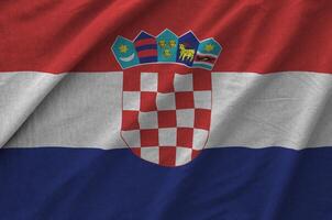 Croatia flag depicted on folded wavy fabric of old cloth photo