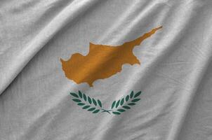 Cyprus flag depicted on folded wavy fabric of old cloth photo