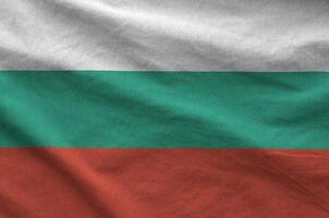 Bulgaria flag depicted on folded wavy fabric of old cloth photo