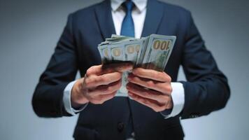Formally dressed man is counting US Dollar bills, close-up. video
