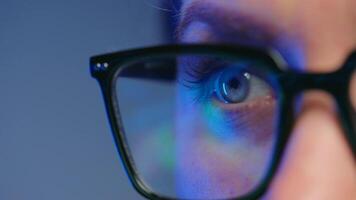 Woman in glasses looking on the monitor and working with data and analytics. video