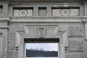 a window with a reflection of a building in it photo
