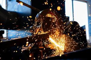 Cutting a metal using cutting machine and the fire sparks splashes outside photo