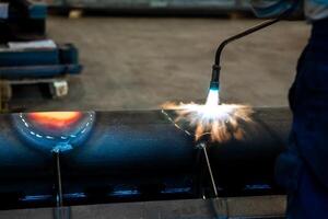 Heating up of metal construction with acetylene and oxygen burner in process of flame straightening with visible red colour of heated metal photo