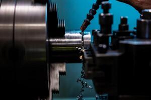 The CNC lathe machine thread cutting at the end of metal cone shape parts The hi technology metal working processing by CNC turning machine photo