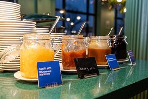 Array of Homemade Jams and Honey in Glass Jars at Buffet in hotel photo