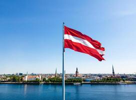Huge Latvian flag flutters in the wind with Riga old town in the background in Latvia Beautiful summer day photo