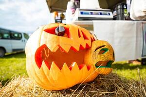 A pumpkin on a straw with an angry expression on Halloween photo