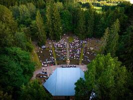 Aerial view of event on stage with full rows of people photo