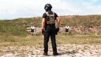 Special forces operatives in tactical gear practicing firearms training at an outdoor shooting range under a cloudy sky photo
