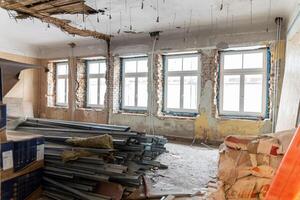 Extensive renovation in progress inside an old building with exposed brick and stacked materials photo