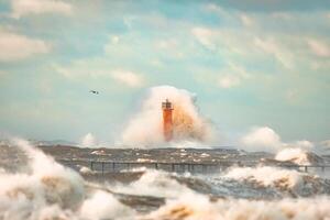 Close up Huge waves crashing lighthouse during the storm Stormy weather in Riga, Latvia photo