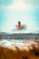 Close up Huge waves crashing lighthouse during the storm Stormy weather in Riga, Latvia photo