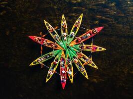 Spectacular aerial view of kayaks forming a star pattern form on a river photo
