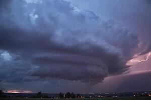 Experience the raw power of nature with this breathtaking image of a supercell storm, showcasing its awe-inspiring structure and dramatic lightning strikes. Captured in stunning detail. photo