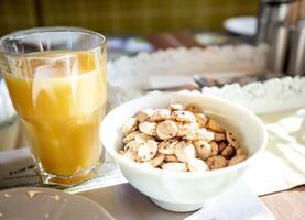 Traditional Breakfast of Cereal with Milk or Yogurt and Freshly Squeezed Juice photo