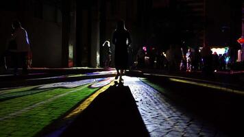 Bright colored rays break through the crowd and a girl dances in the rays video