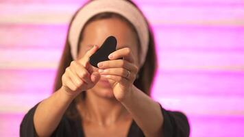 Girl shows Gua Sha on camera close up video
