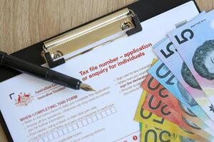 KYIV, UKRAINE - JULY 10, 2024 Australian Tax File Number Application or enquiry for individuals blank form lies on table of Australian Government taxation office photo
