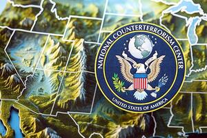 KYIV, UKRAINE - JUNE 26, 2024 United States National Counterterrorism Center coat of arms on paper map of United States photo