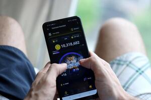 KYIV, UKRAINE - APRIL 20, 2024 Hamster Kombat telegram bot on smartphone screen. Hamster Kombat is a viral Telegram crypto game for earn HMSTR tokens by managing virtual crypto exchange photo