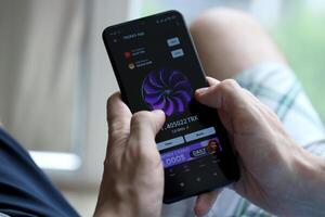 KYIV, UKRAINE - APRIL 20, 2024 Tronix App telegram bot on smartphone screen. Tronix App is a viral Telegram based crypto game for earn TRX tokens by managing virtual crypto exchange photo