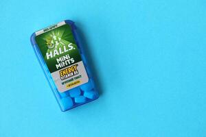 KYIV, UKRAINE - APRIL 20, 2024 Halls mini mints mint twist energy vitamin b6 small blue case with hard mints inside on blue background photo
