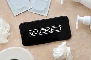 KYIV, UKRAINE - JANUARY 23, 2024 Wicked adult content website logo on display of iPhone 12 Pro photo
