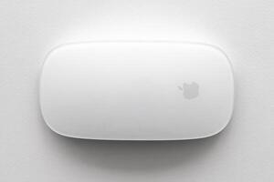 KYIV, UKRAINE - NOVEMBER 27, 2023 Apple Magic Mouse 3rd generation lies on white background photo