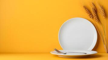 Top down view of a white plate isolated on yellow background with fork and knife with copy space photo