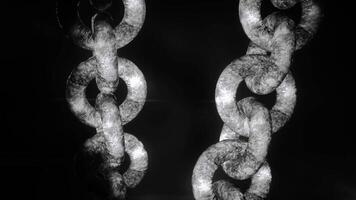 Abstract industrial background with metal large rusty chains hanging isolated on a black background. Motion. Silver chains, close up. video