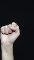 Close-up of hand with fist. Isolated on ablack background. video