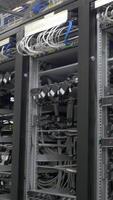Device for mining crypto currency. Row of bitcoin miners set up on the wired shelfs. Mining cryptocurrency. Bitcoin farm. Machines for mining cryptocurrency, bitcoin. Electronic device at day video