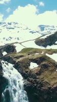 Scenic view over river with white water and distant mountain with high waterfall. View from the top of the waterfall and the snowy mountains video