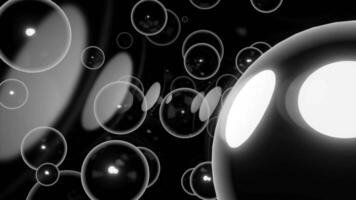 Black background. Design.Bright bubbles with white and yellow illumination of large size in the animation fly in different directions. video