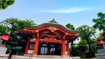 Wakabayashi Inari Shrine fox fox and red shrine building.Wakabayashi Inari Shrine is a shrine in Setagaya Ward, Tokyo. Since it received a donation of shrine territory in 1769, it is presumed photo