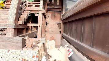 A fox hiding behind a small shrine at Yoshimori Inari Shrine,is a shrine located in a residential area of Hamadayama 2-chome, Suginami-ku, Tokyo, Japan. The god of the mansion of the descendants photo