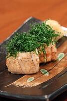 Sushi Joe Crispy Kale, salmon roll, cream cheese, fried kale and chives on plate photo