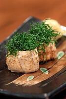 Sushi Joe Crispy Kale, salmon roll, cream cheese, fried kale and chives on plate photo