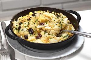 Cod with Pereira Ignacio, classic Portuguese recipe with port cod, onion, parsley, egg and olive oil photo