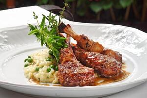 rack of lamb with risotto on plate photo