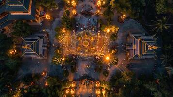 A top view of a large Buddhist temple ground during Visakha Bucha Day, crowds of devotees moving in a candlelit procession, intricate patterns of lights on the floor, surrounding greenery. photo