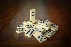 dominoes scattered on wooden table photo