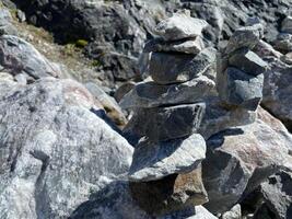 pyramid of balanced stones. tower of minerals in a rocky mountainous area. natural horizontal background. photography was taken in Republic of Karelia in Russia photo