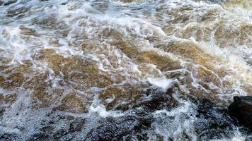 Aerial view of the waves and rapids of the wild river. abstract nature background. surface of water with white foam. horizontal photography photo